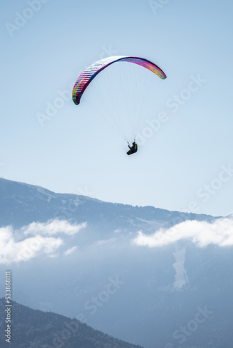 A paraglider in the sky over the mountains 