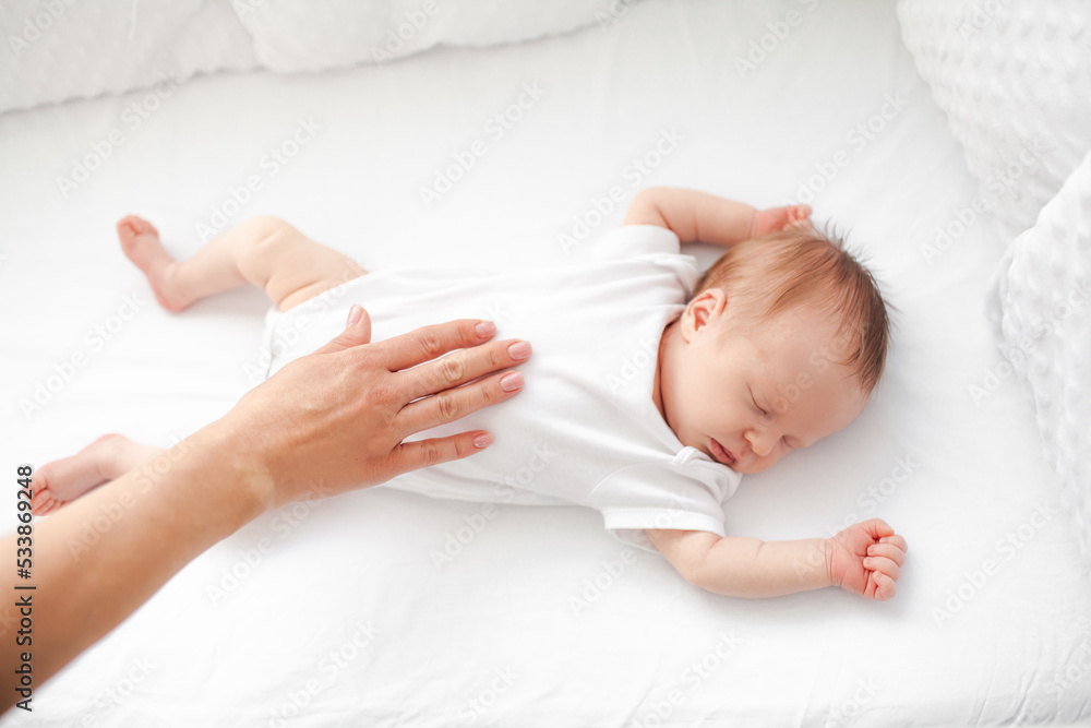 Home portrait of a sleeping newborn baby in a crib Home portrait of a sleeping newborn baby in a crib