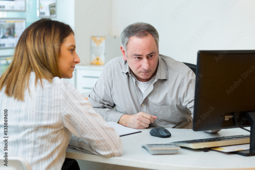 woman talking with a male office worker woman talking with a male office worker