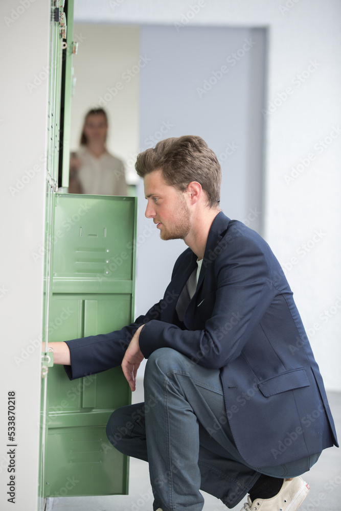 student in locker room at college