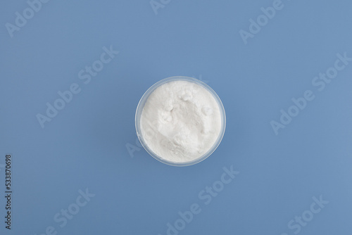 Sodium Carboxymethyl Cellulose Powder, NaCMC. Food additive E466 in bowl, top view. Stabiliser and Thickener. Agar and Gelatin replacer. Glazing agent