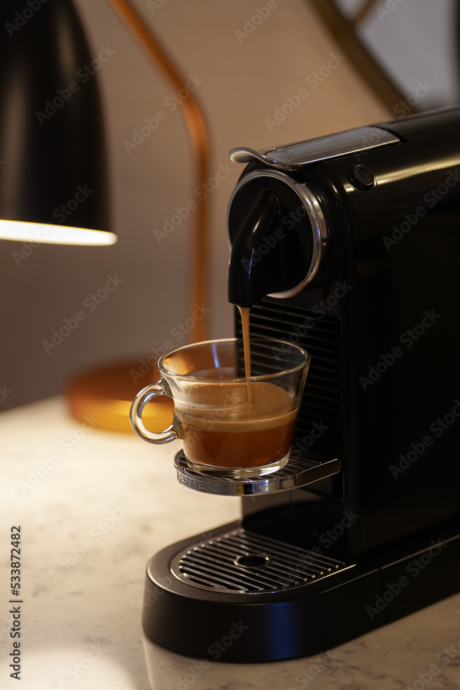 Nespresso coffee machine making an espresso drink from a coffee capsule.  Romania, 2022. Stock Photo | Adobe Stock