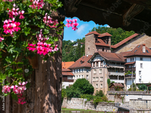 Old medieval town of Fribourg through old wooden bridge over the Saane river in Fribourg, Switzerland photo