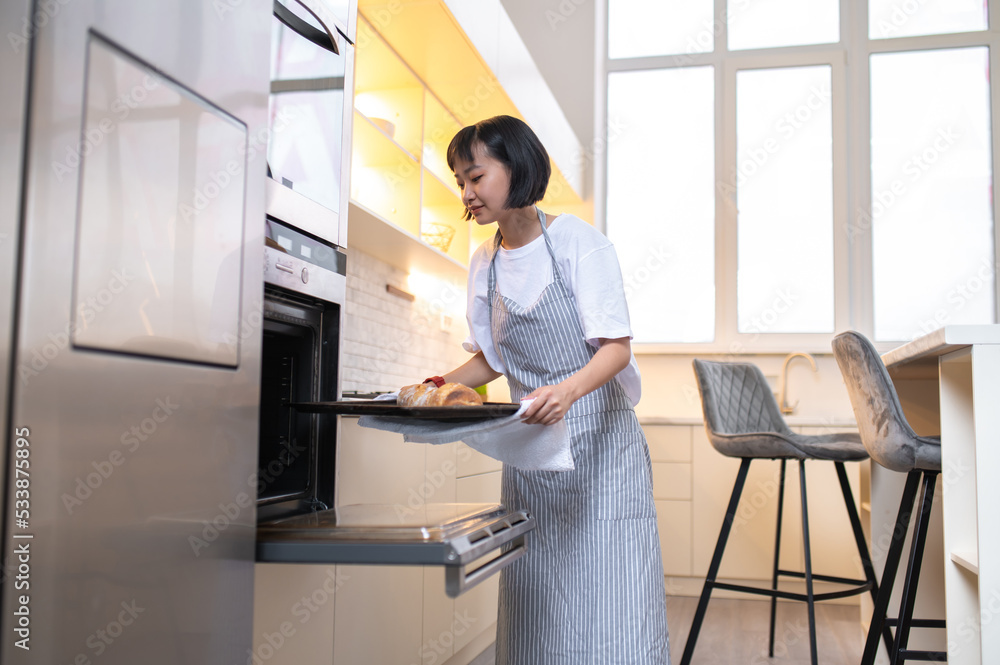 Young Asian woman preparing a dessert at home Young Asian woman preparing a dessert at home