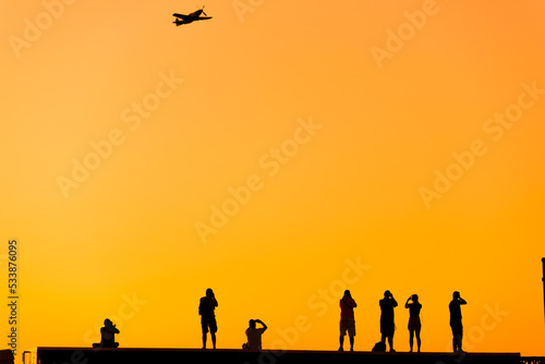 Silhouette of some photographer people on sunset. © ardasavasciogullari