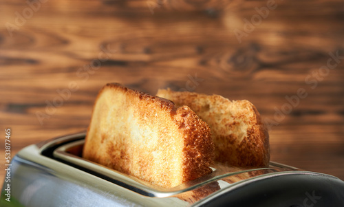 Toast fried in a toaster close-up. Concept - making breakfast. Beautiful photos of delicious food.