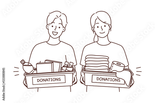 Happy volunteers with donation boxes 
