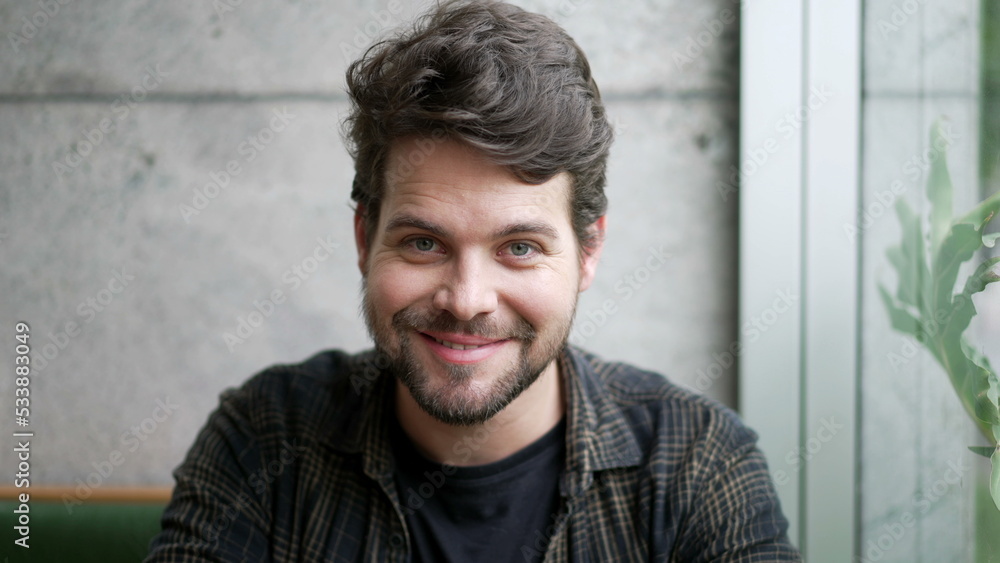 Portrait of a young man smiling at camera. Closeup male person smile looks at camera. Millennial guy Portrait of a young man smiling at camera. Closeup male person smile looks at camera. Millennial guy