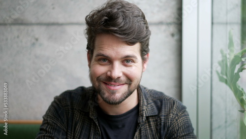 Portrait of a young man smiling at camera. Closeup male person smile looks at camera. Millennial guy © Marco