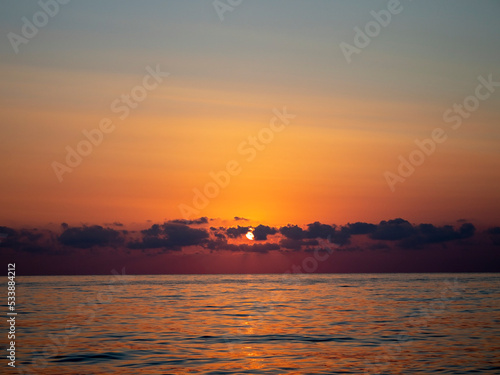 Fantastic Sunset on the Ocean. Nspirational Calm Sea with Sunset sky. Meditation Ocean and Sky Background. Colorful Horizon. photo