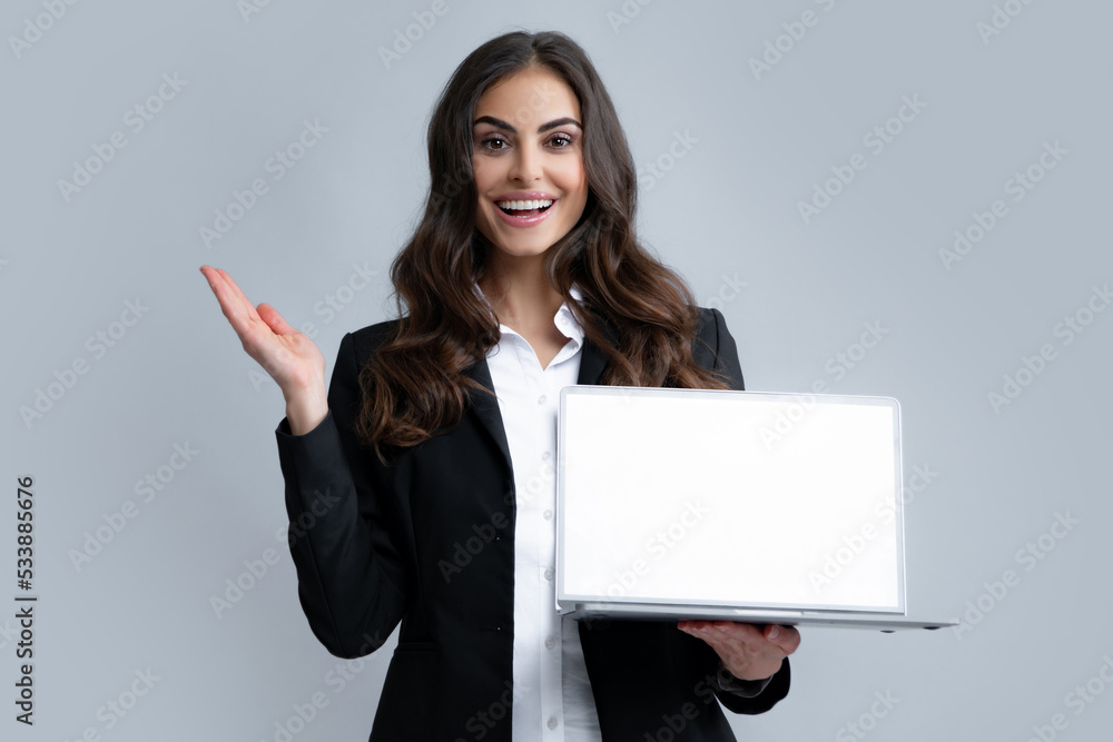 Woman holding laptop with empty mock up screen for copy space. Business women in suit excited something in laptop screen. Portrait of business lady holding notebook. Woman holding laptop with empty mock up screen for copy space. Business women in suit excited something in laptop screen. Portrait of business lady holding notebook.