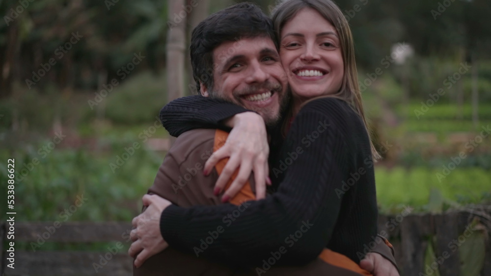 Two friends embrace. male and female people hugging each other at night standing outdoors in nature background looking at camera Two friends embrace. male and female people hugging each other at night standing outdoors in nature background looking at camera