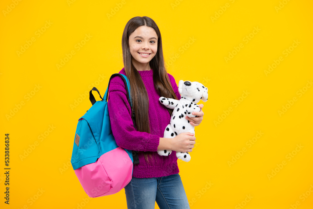 School girl hold toy. School children with favorite toys on yellow isolated background. Childhood concept. School girl hold toy. School children with favorite toys on yellow isolated background. Childhood concept.