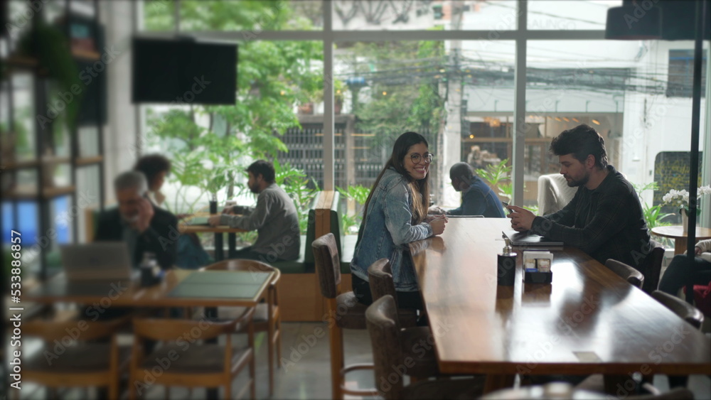 Interior of coffee shop place with people. Cafe restaurant with men and women inside Interior of coffee shop place with people. Cafe restaurant with men and women inside