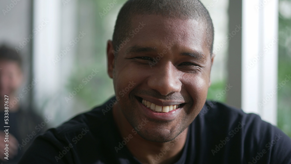 Happy African American man portrait closeup face. A black person smiling at camera. A Brazilian guy Happy African American man portrait closeup face. A black person smiling at camera. A Brazilian guy