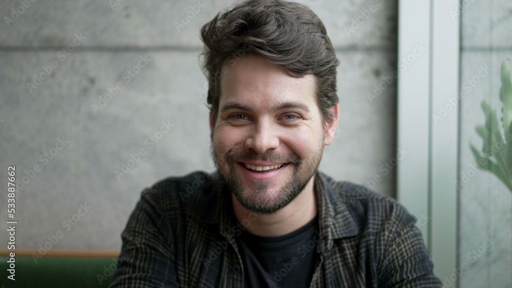 Fototapeta premium Handsome man portrait face closeup smiling. 30s person looking at camera