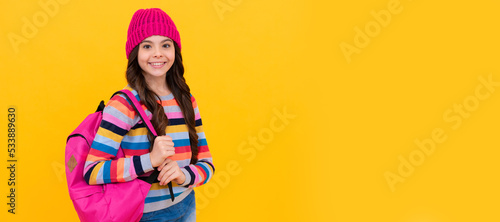 happy hipster teen girl with backpack going to school, chilshood. Portrait of schoolgirl student, studio banner header. School child face, copyspace.