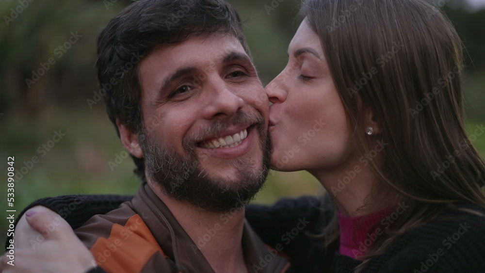 Couple in 30s embrace standing outdoors at dusk evening wearing sweaters during cold night. Friends hugging each other Couple in 30s embrace standing outdoors at dusk evening wearing sweaters during cold night. Friends hugging each other