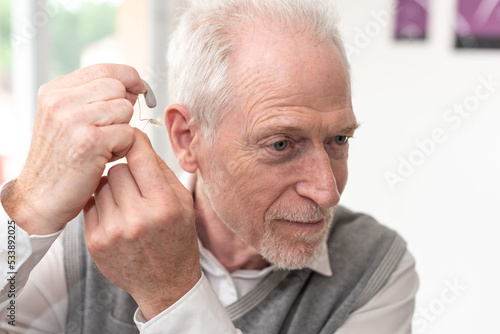 Man putting hearing aids