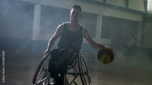 A hispanic disabled basketball player in a wheelchair portrait with serious expression. Determination and motivation concept © Marco