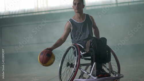 A disabled athlete in wheelchair playing basketball. Handicapped sportman © Marco
