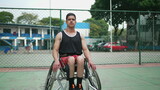 A Brazilian disabled athlete on wheelchair portrait looking at camera at basketball court