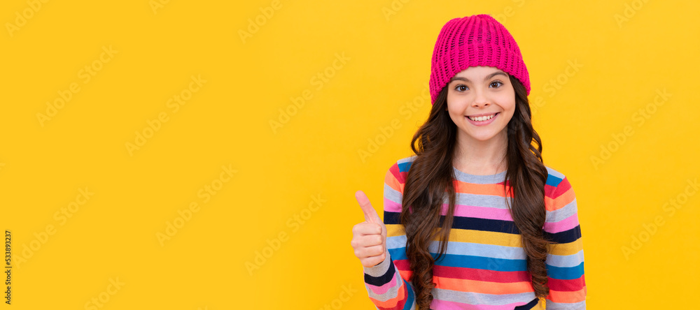 happy teen girl showing thumb up gesture, excellence. Child face, horizontal poster, teenager girl isolated portrait, banner with copy space.