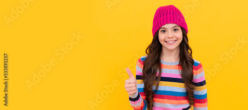 happy teen girl showing thumb up gesture  excellence. Child face  horizontal poster  teenager girl isolated portrait  banner with copy space.