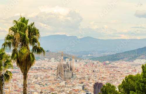 View over Barcelona with Sagrada Família and palm trees