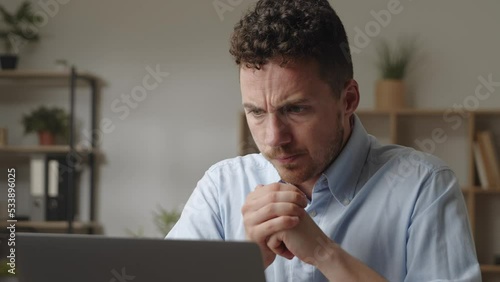 Stressed nervous young man in shirt work on laptop makes deadline urgent task, feels exhausted massages temples
