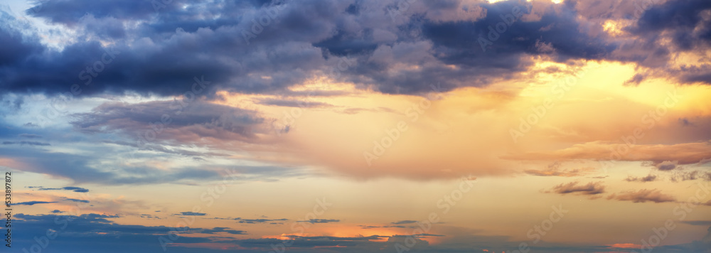 Abstract beautiful nature background, bright sunset sky with storm clouds, panorama shot