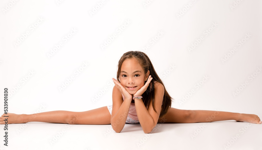 Foto de Girl sitting on floor with her legs wide apart do Stock