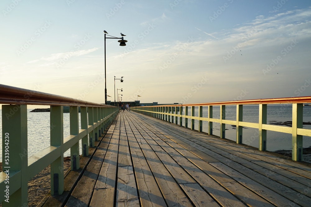 Fototapeta premium Wooden pier connecting Malmo's Ribersborg Beach with the Ribersborgs Kallbadhus public bath