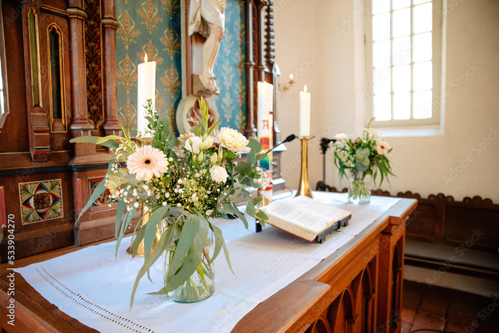 Decorated altar in a Protestant church in Germany. The Bible and