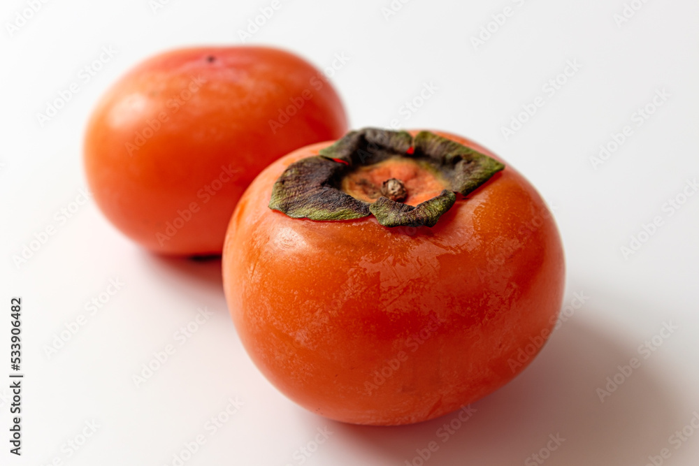 ripe persimmon on a white background ripe persimmon on a white background
