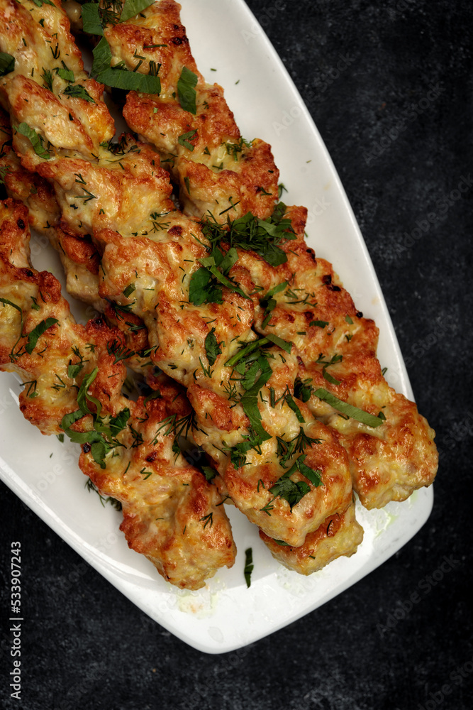 Chicken lulia kebab with herbs on a plate Chicken lulia kebab with herbs on a plate