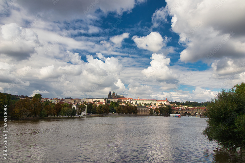 Vltava river , Charles bridge and Prague Castle in background in cloudy summer day.	
