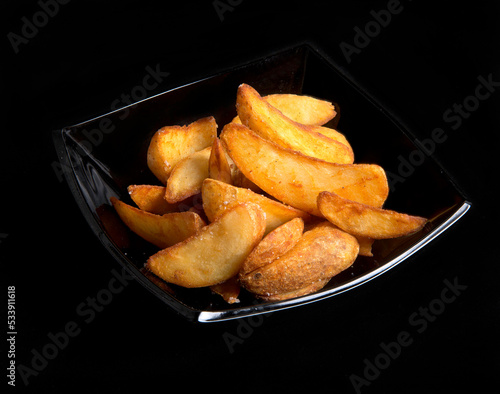 fried french fries on a black background