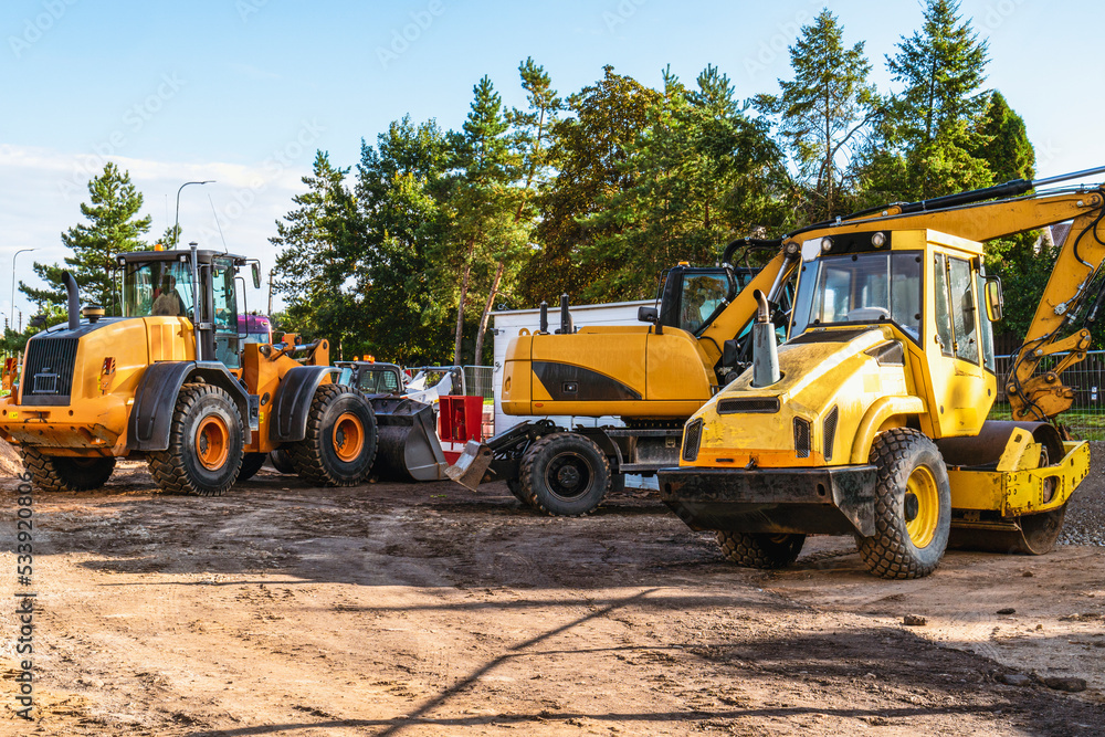 Heavy industrial machinery at construction site parking area