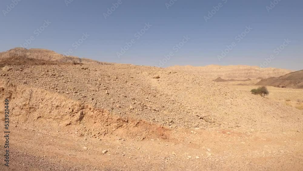 Car driving on a country road at the desert with mountains and blue sky in the background. Car driving on a country road at the desert with mountains and blue sky in the background.