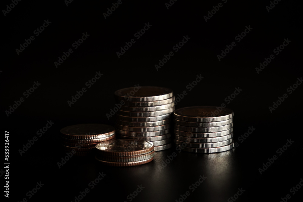 Stack of coins on black background, Saving money concept Stack of coins on black background, Saving money concept