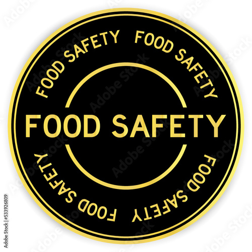 Black and gold color round label sticker with word food safety on white background