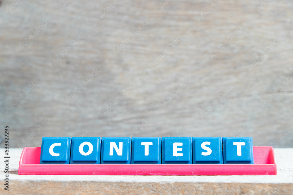 Tile alphabet letter with word contest in red color rack on wood background