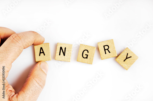 forming the word ANGRY with letter tiles
