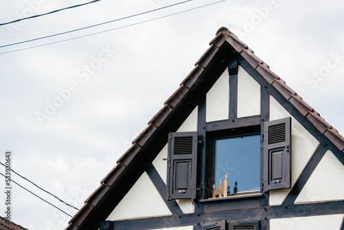 Candles made from wood at the window sill of a rustic village house