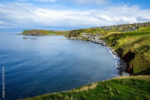The picturesque village of Gardenstown, Scotland on the northern coast of the UK with blue skies