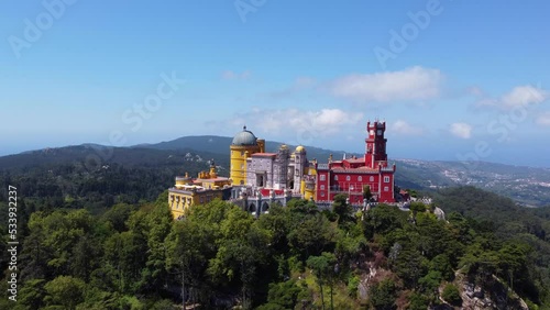 Aerial drone view of Park and National Palace of Pena in Sintra, Portugal during a sunny day. Unesco World Heritage. Historic visits. Holidays and summer vacation tourism. Colorful palace. 
