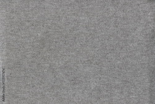 The texture of soft natural knitted fabric is light gray. Natural cotton coarse plain fabric. Natural fabric background.