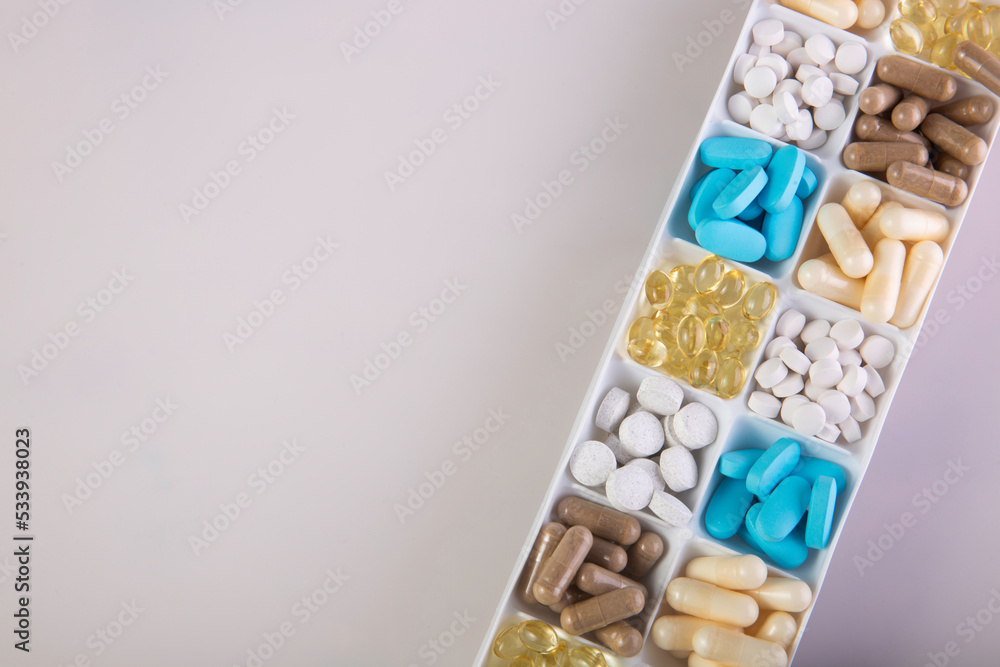 plastic container with pills on white background plastic container with pills on white background