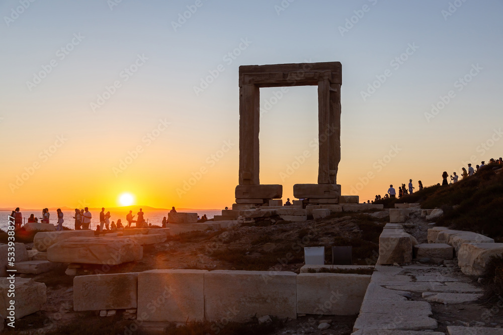 Naxos island, sunset over Temple of Apollo, Cyclades Greece. People enjoys the sundown background.
